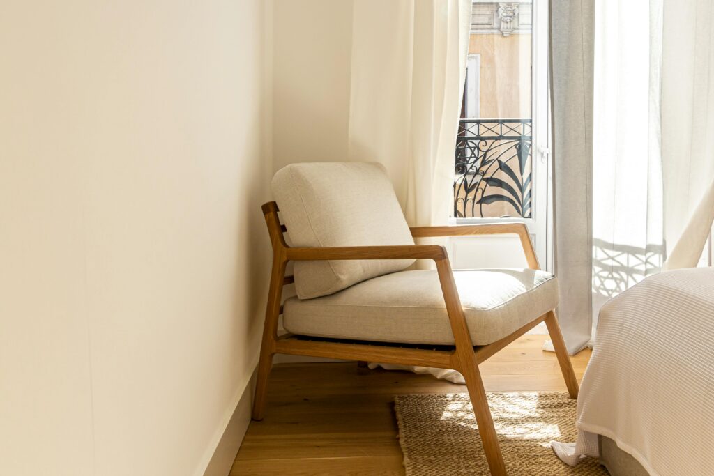 A cozy Scandinavian-style chair in a bright, elegant Madrid interior.